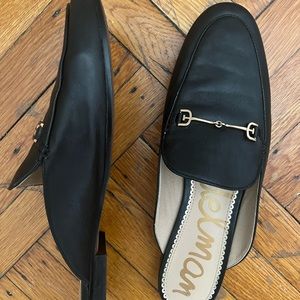 Sam Edelman black leather mules with gold accent.